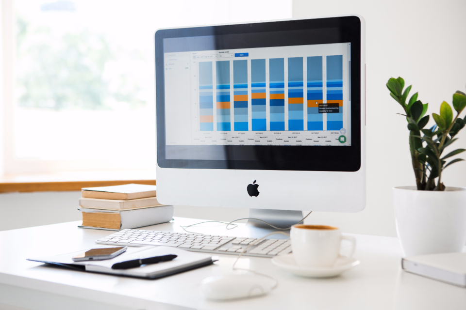 Analytics dashboard shown on a desk next to a keyboard and notes